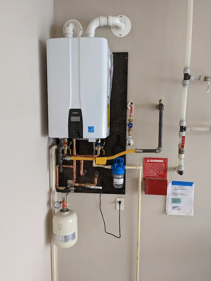 Professional plumber installing copper piping in a Chambersburg home